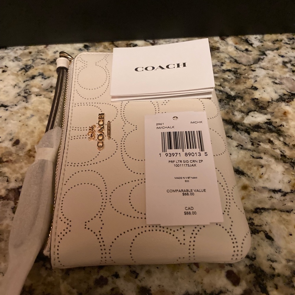 Brand new Authentic COACH wristlet with barcode